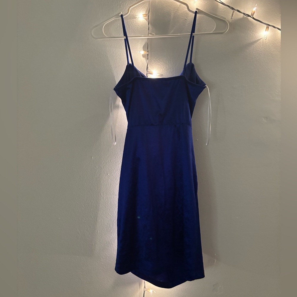 Royal blue dress with spaghetti straps. It has a cowl neck and fitted silhouette